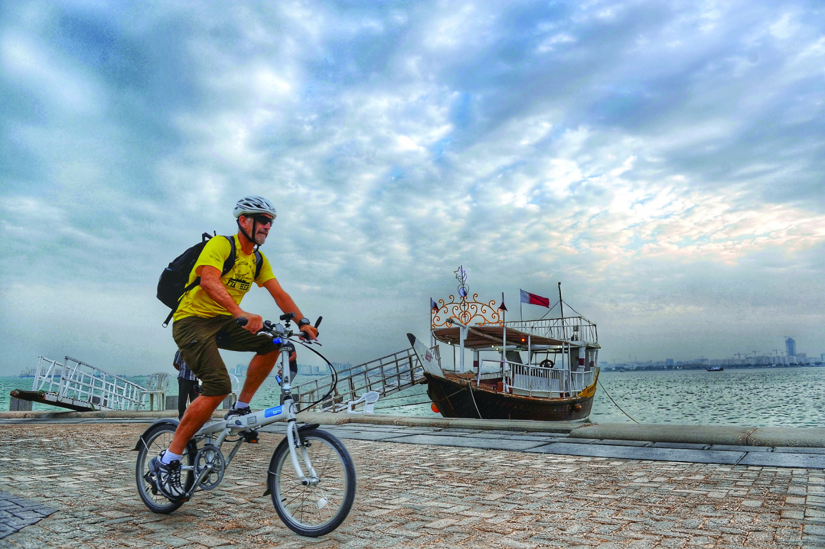 A cyclist pedals along the Corniche under cloudy skies in Doha yesterday. 
Pic: Salim Matramkot / The Peninsula