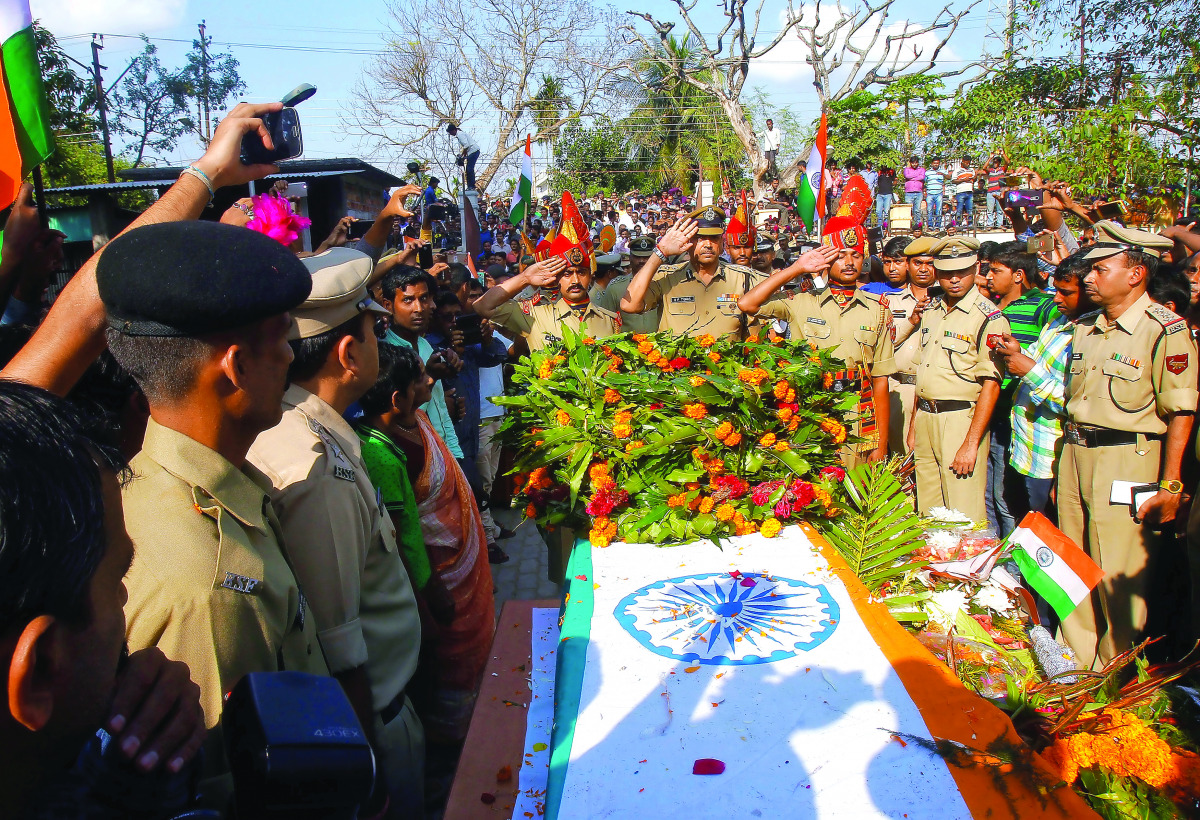 Border Security Force officers salute at the coffin of Sambhu Satmura, who was killed in a land mine blast at the border, during a wreath laying ceremony in Agartala, yesterday.
