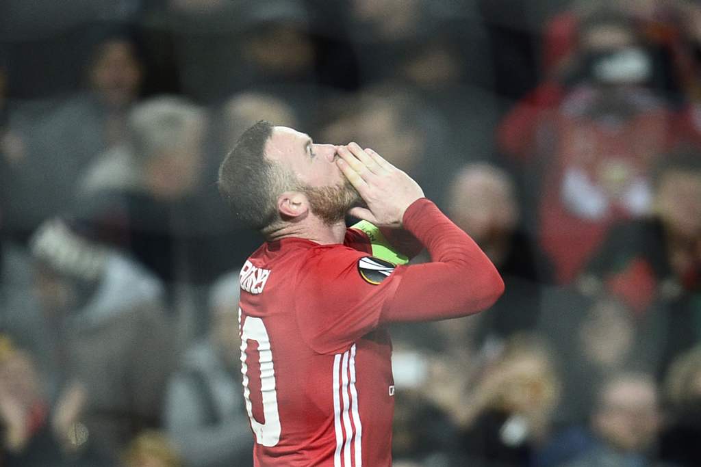 Manchester United's English striker Wayne Rooney celebrates scoring the opening goal during the UEFA Europa League group A football match between Manchester United and Feyenoord at Old Trafford stadium in Manchester, north-west England, on November 24, 20