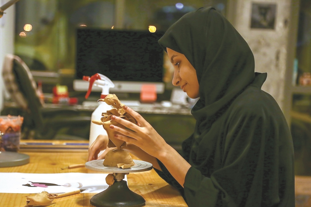 Qatari artist Hana Al Saadi working on a sculpture during the first open studio evening at the Fire Station on Thursday
