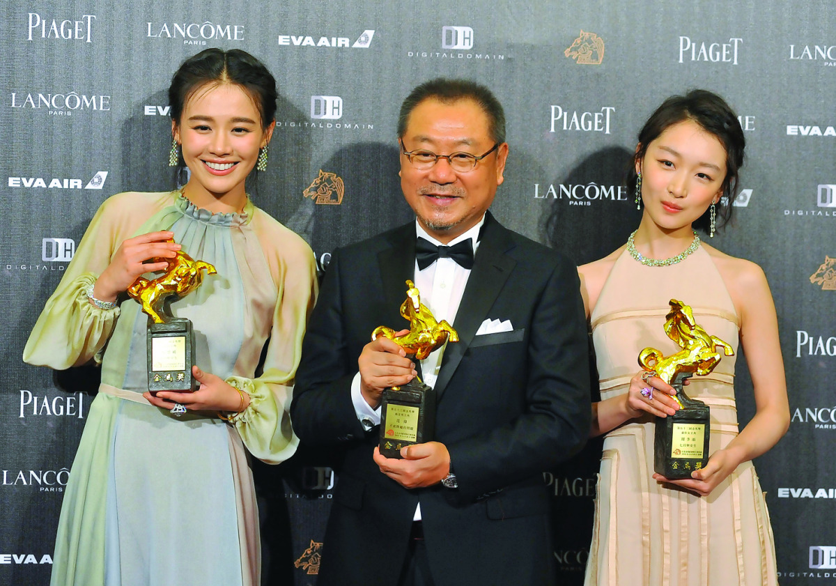 Chinese actress Ma Sichun (left), Chinese actor Fan Wei (centre) and Chinese actress Zhou Dongyu display trophies after winning the Best Leading Actor and the Best Leading Actress during the 53rd Golden Horse Film Awards in Taipei yesterday