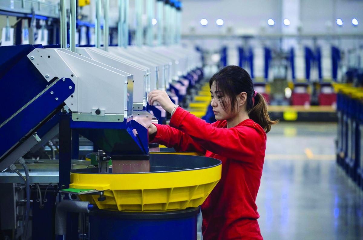 A worker checking the production in the packaging section of the newly opened Lego factory in Jiaxing, China. Lego's first Asian factory opened in China, the company said.  
