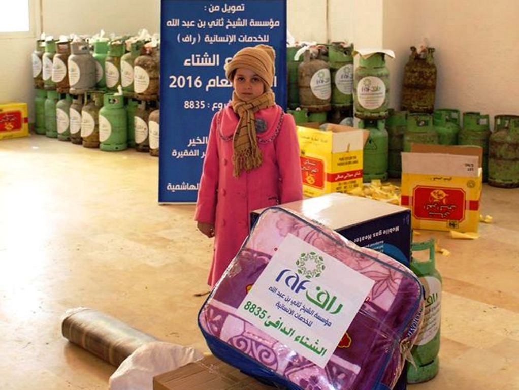  Syrian refugees in Jordon receiving winter assistance at a distribution centre set by RAF.