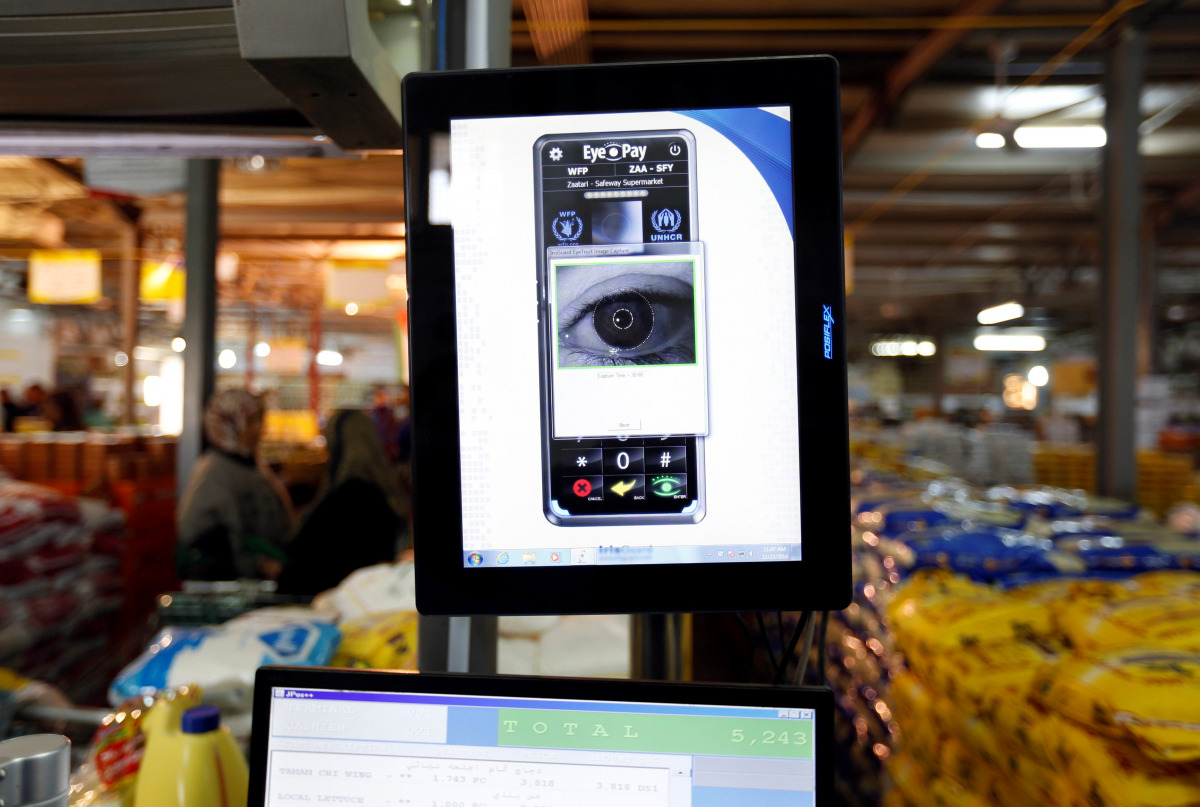 Syrian refugees receive foodstuff through the iris scan service launched by the World Food Program at Tazweed centre in the Al-Zaatari refugee camp, in Mafraq, Jordan, near the border with Syria, November 23, 2016. Picture taken November 23, 2016. REUTERS