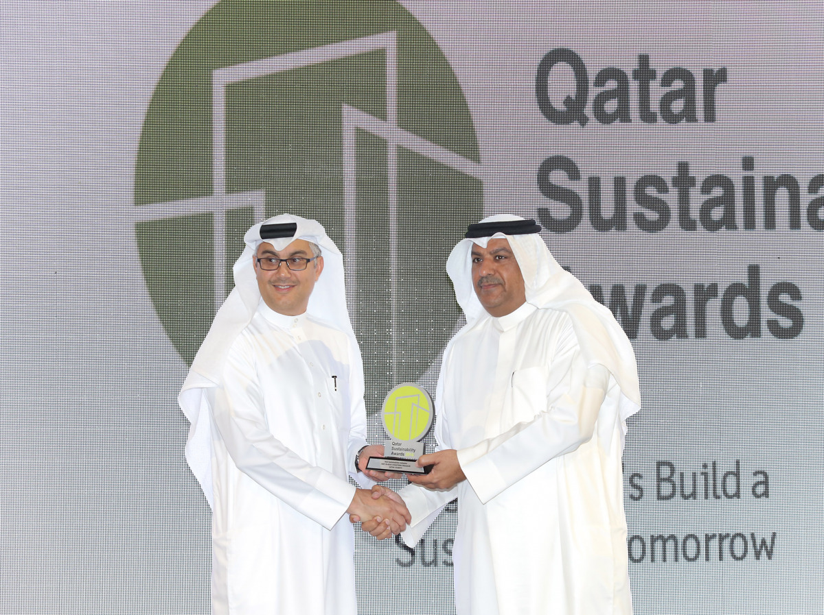 A senior official from Qatar Charity receives the award.