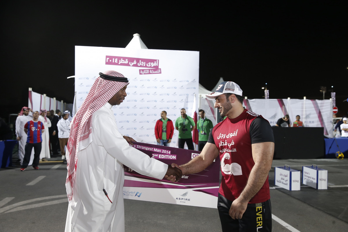 Abdullah Al Khater, Manager of Events at Aspire Zone Foundation, congratulates  one of the participants during the 2014 Qatar's Strongest Man competition in this file photo. 