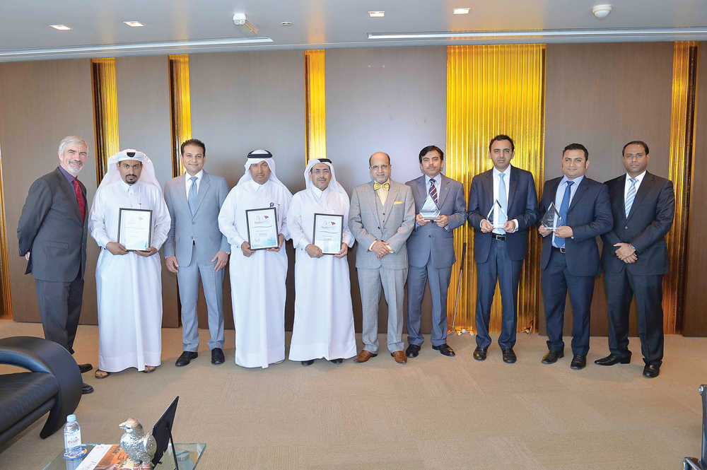 Doha Bank CEO Dr R Seetharaman ( sixth left) and otehr officials with the awards