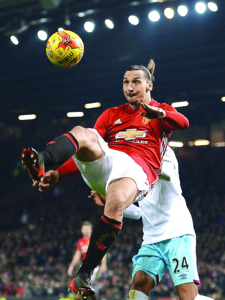 Manchester United's Zlatan Ibrahimovic jumps to cross the ball during their League Cup match against West Ham United at Old Trafford in Manchester, England, on Wednesday.