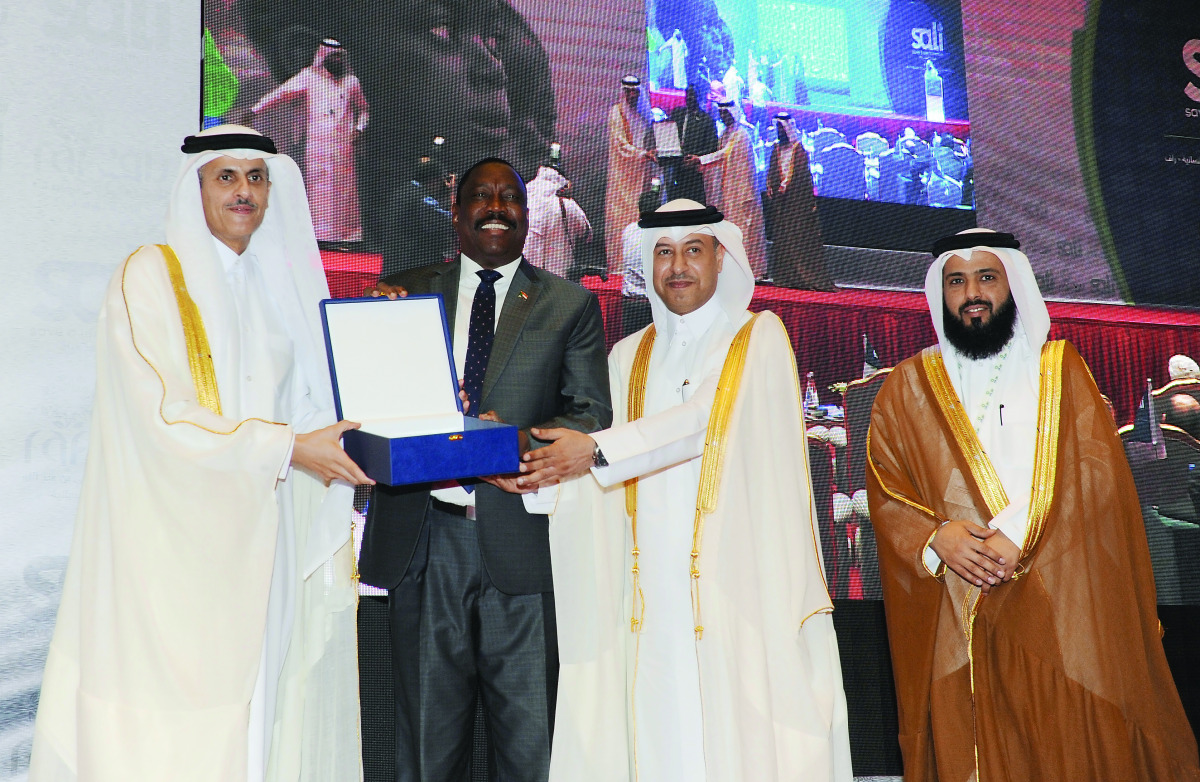 Minister of Administrative Development, Labour and Social Affairs H E Dr Issa bin Saad Al Jafali Al Nuaimi (third left), and Chairman of RAF, Dr Sheikh Khalid bin Thani Al Thani (left) honour Sudan's Federal Minister of Health, Bahar Idris Abu Garda, duri
