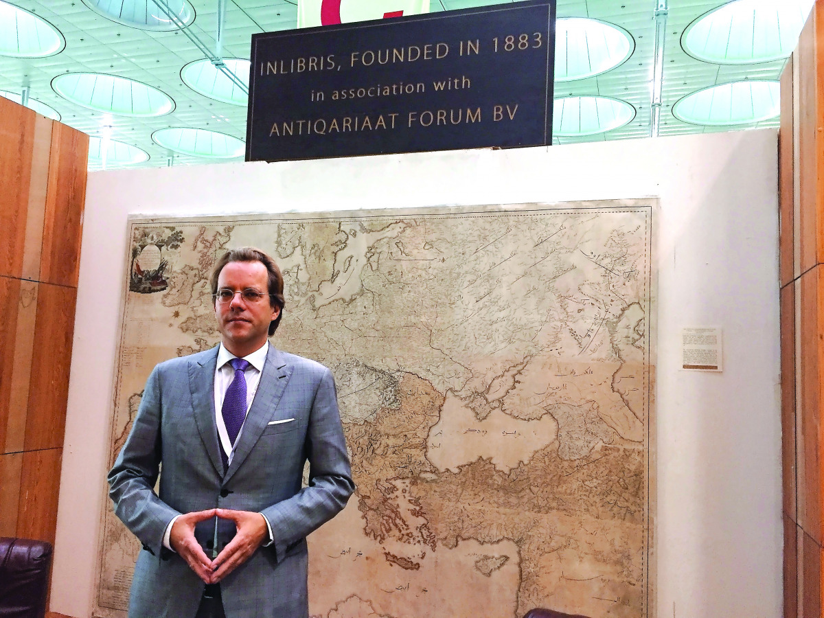 Hugo Wetscherek of Antiquariat Inlibris with an 1803 wall map, the largest of its kind printed for Middle Eastern audience.  Pic: Raynald C Rivera / The Peninsula