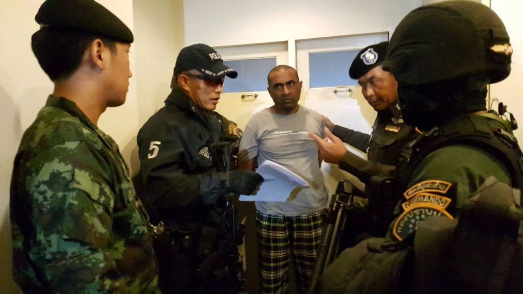 This handout received by the Royal Thai Police and taken on December 3, 2016 shows Abdul Rehman (C), a Pakistani national who was arrested in Bangkok on December 2 on suspicion of starting a devastating 2012 factory fire in Karachi killing 259 people, at 