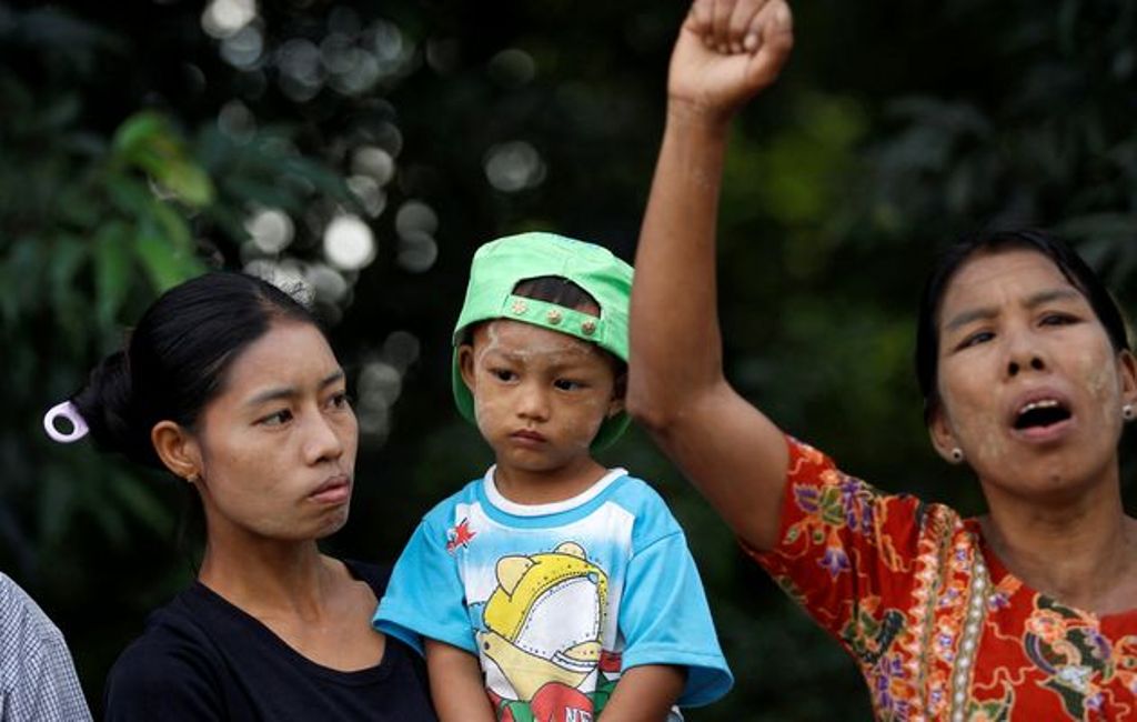 A woman carrying her son watches as a local protests against the visit by former U.N. Secretary-General Annan in Rakhine state. File photo 
Image by: SOE ZEYA TUN / REUTERS