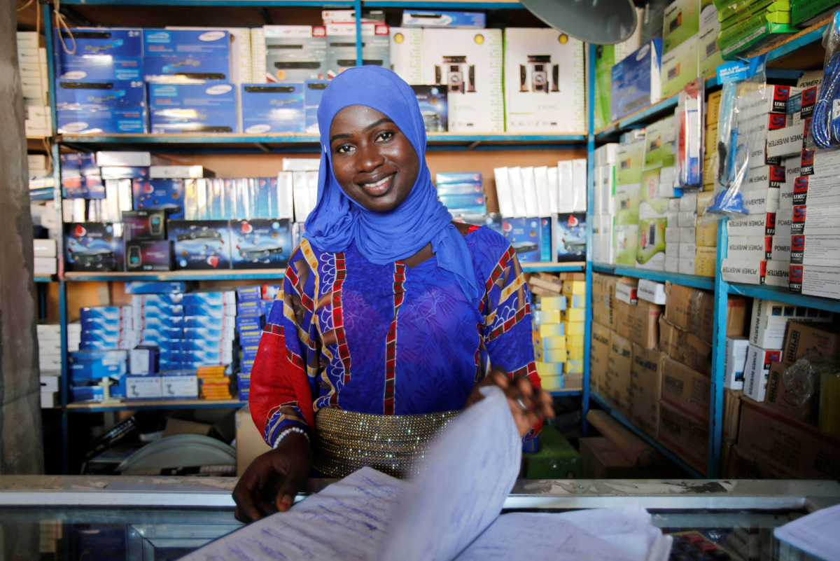 A woman smiles in her shop in Serekunda, Gambia December 3, 2016. REUTERS/ Thierry Gouegnon