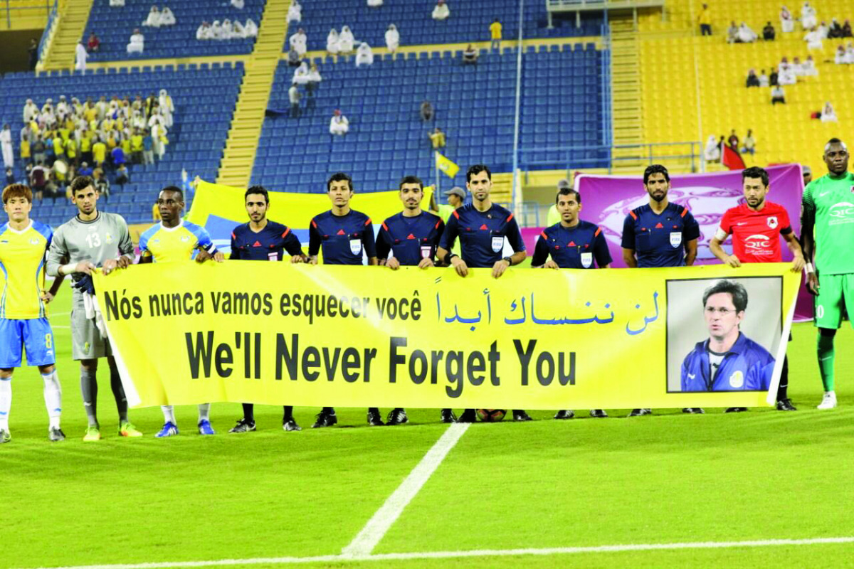 Players pay tribute to the former Al Gharafa head coach Caio Junior who died following the aeroplane disaster that took the lives of 77 people in Colombia, prior to their Qatar Stars League match at the Al Gharafa Stadium yesterday.
