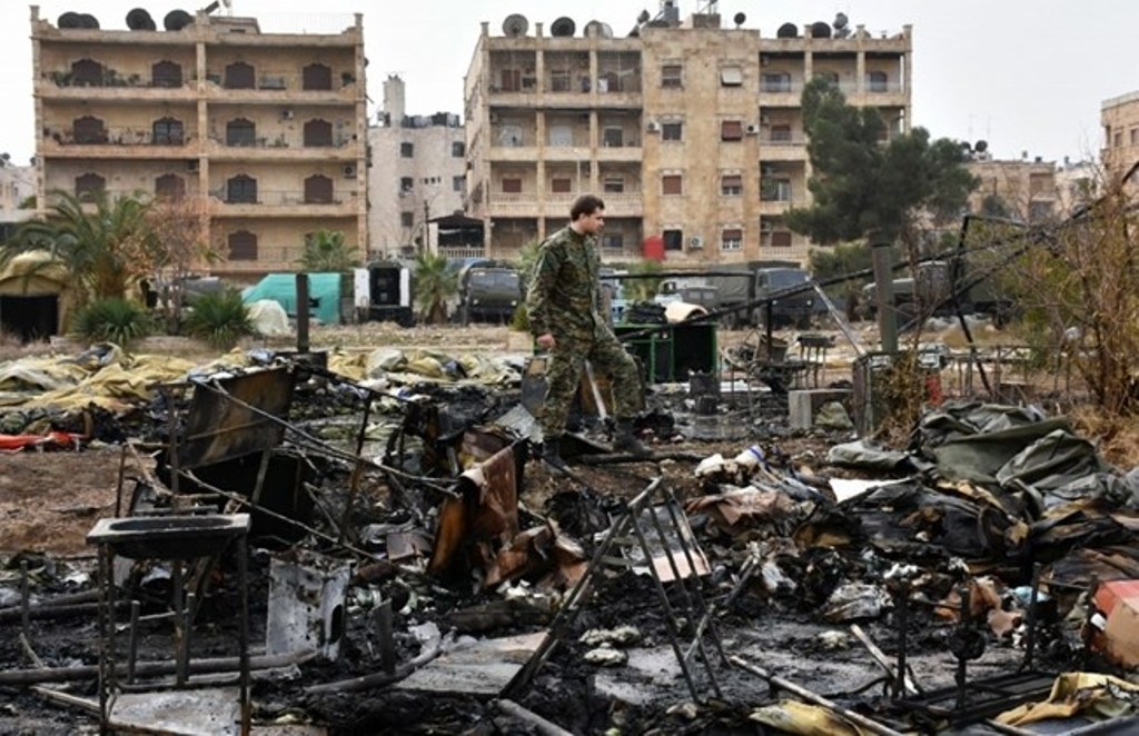 A Russian soldier inspects the damage at a field hospital that was reportedly destroyed by rebel shelling on December 5, 2016 in the Furqan neighborhood of the government-held side of west Aleppo. AFP / GEORGE OURFALIAN