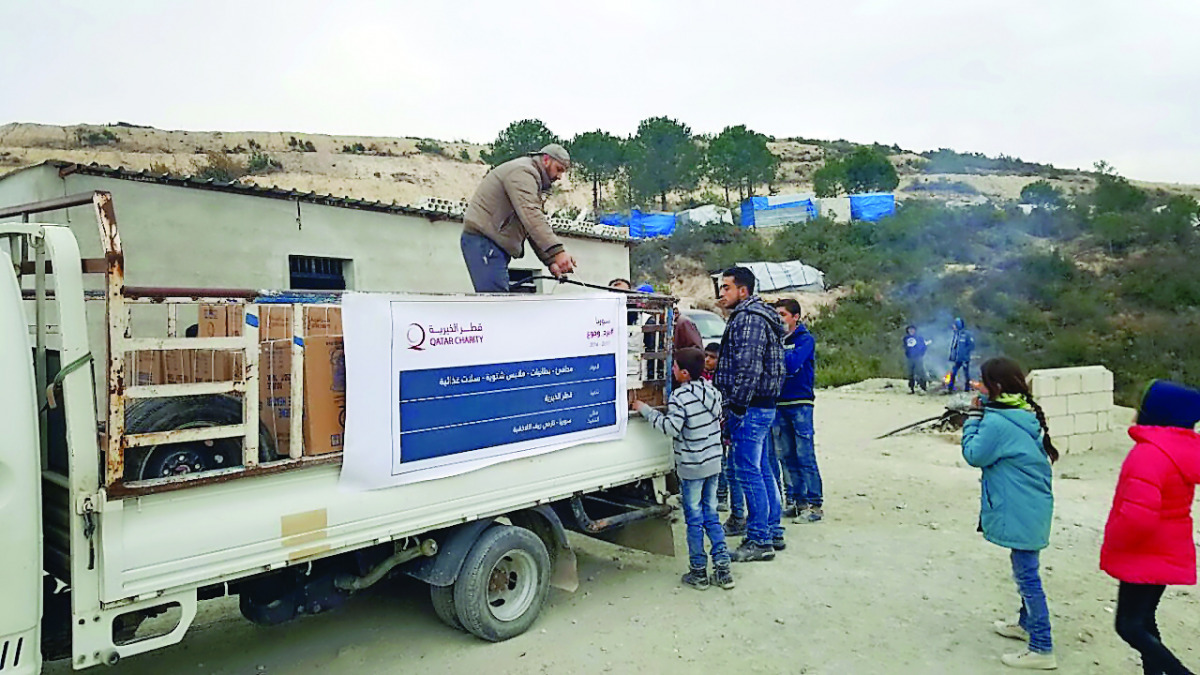 A Qatar Charity vehicle distributing winter provisions to Syrian refugees in Lebanon. 