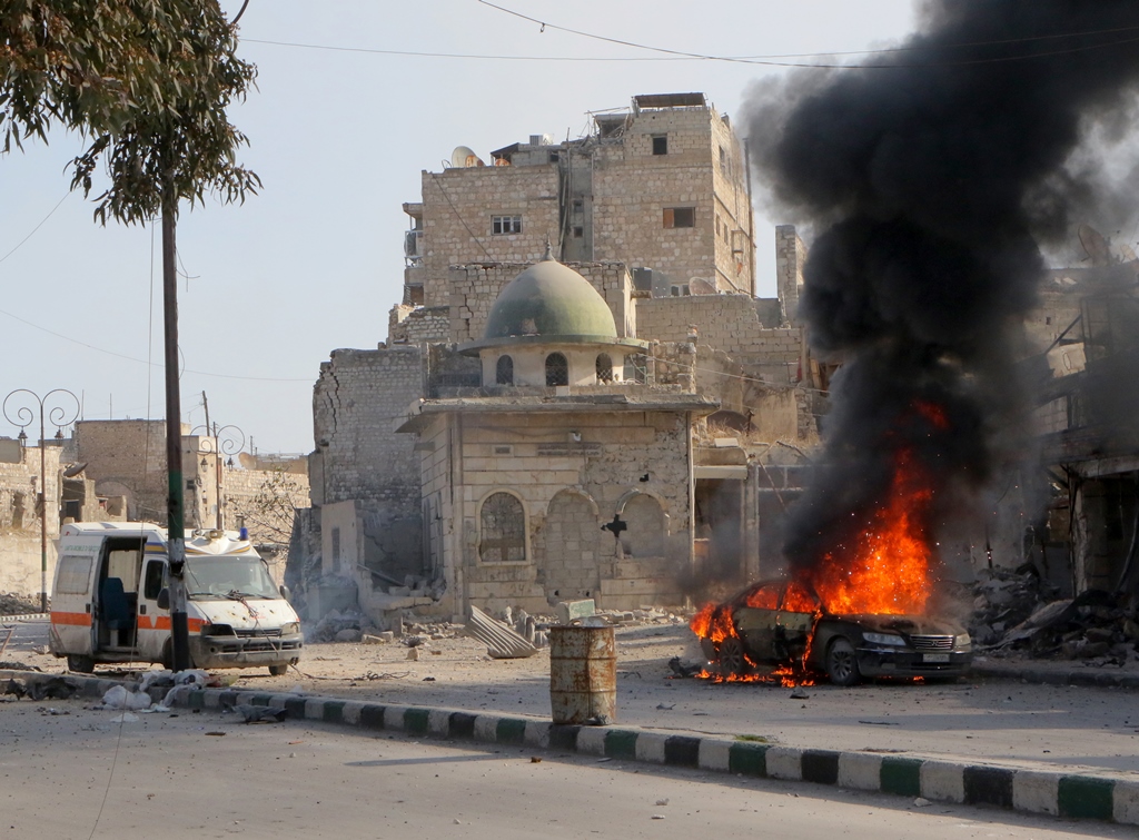  Smoke rises from a vehicle after Assad Regime forces' artillery units attacked with howitzers to residential areas in al-Shear neighbourhood of Aleppo, Syria on December 6, 2016. (?brahim Ebu Leys - Anadolu Agency)