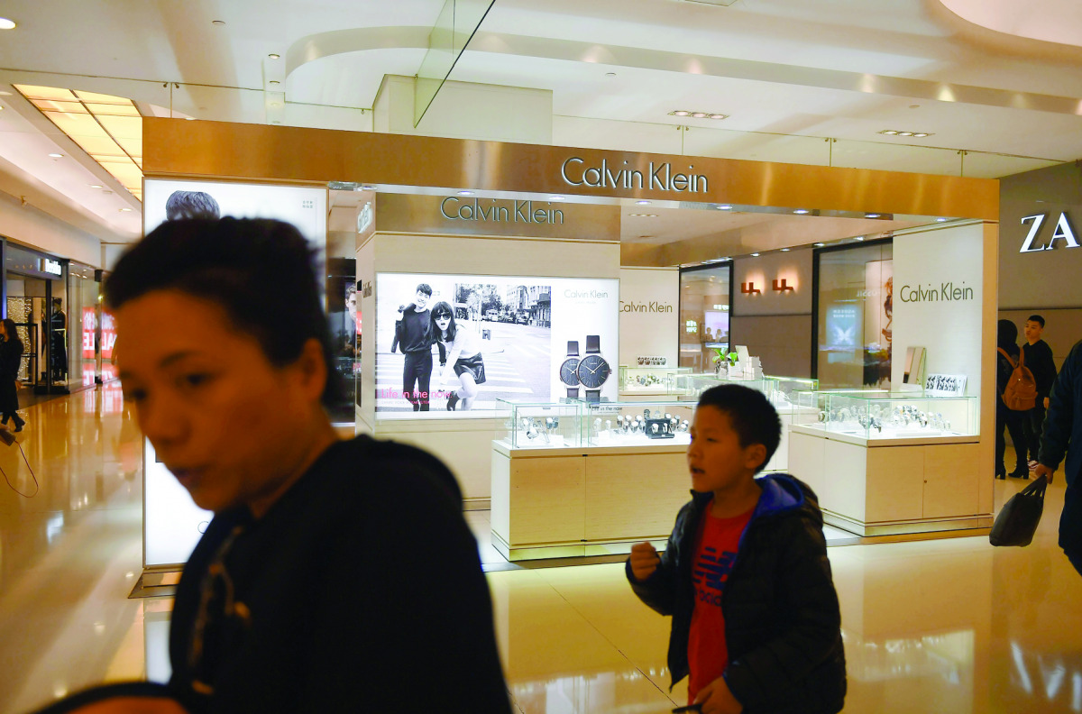 People walk past a store in a shopping mall in Beijing yesterday.