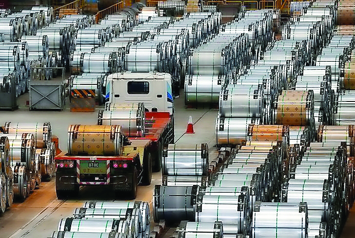 A truck drives past rolls of steel inside the China Steel Corporation factory, in Kaohsiung, southern Taiwan.