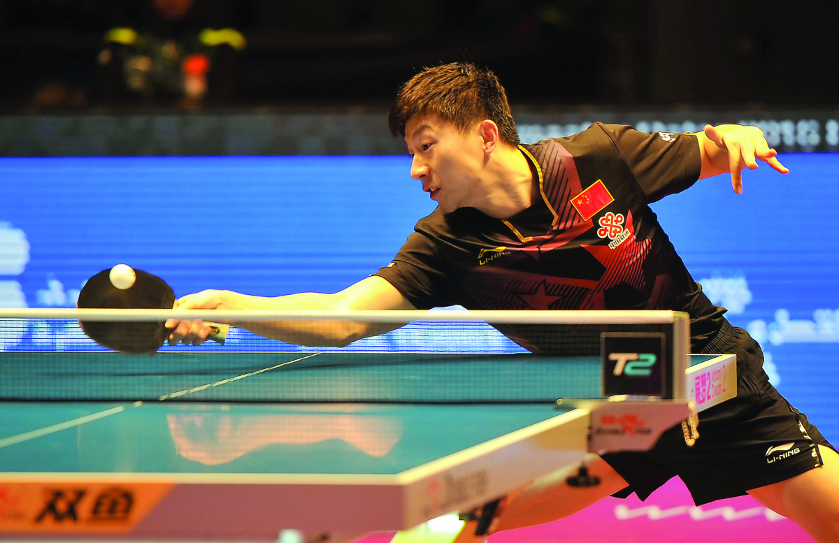Ma Long of China in action against South Korea's Jeoung Youngsik during the ITTF World Tour Grand Finals at Ali Bin Hamad Al Attiyah Arena in Doha yesterday. Ma Long won 11-9, 11-8, 11-8, 14-12.
Pictures by: Abdul Basit / The Peninsula