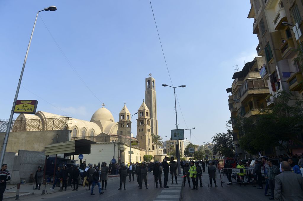 Egyptian security forces gather at the site of an explosion at the Saint Mark's Coptic Orthodox Cathedral on December 11, 2016 in the Abbasiya neighbourhood in the capital Cairo. Copts, who make up about 10 percent of Egypt's population of 90 million, hav