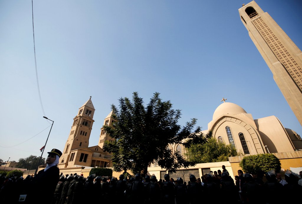 Egyptian riot police stand guard as Christians shout slogans in front of Cairo’s Coptic Cathedral after an explosion inside the cathedral in Cairo, Egypt December 11, 2016. REUTERS/Amr Abdallah Dalsh
