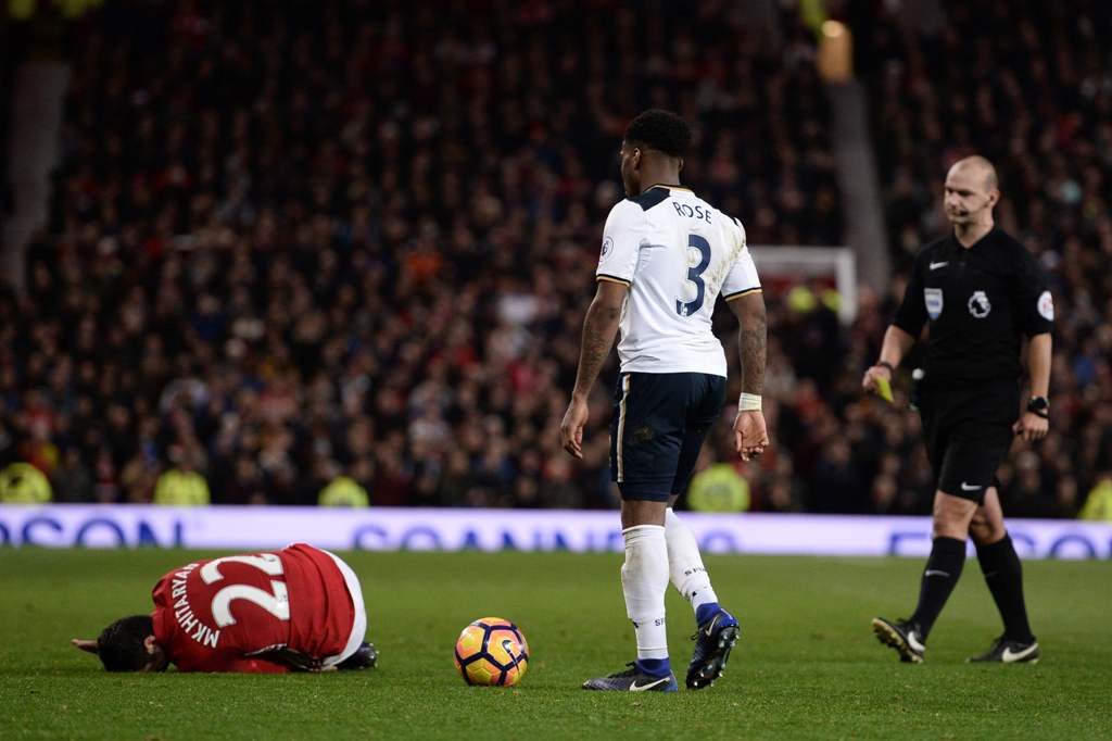 Manchester United's Armenian midfielder Henrikh Mkhitaryan (L) lies injured after a challenge by Tottenham Hotspur's English defender Danny Rose during the English Premier League football match between Manchester United and Tottenham Hotspur at Old Traffo