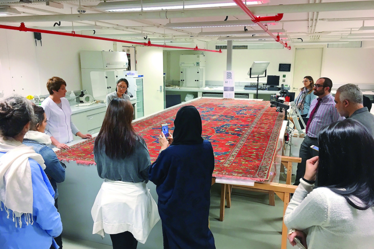 Tatiana, one of the textile conservators, explains the conservation process for a Turkish Ushak carpet dating to between late 15th to early 16th century at the MIA Conservation Laboratory, yesterday.