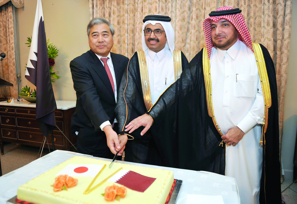 H E Dr Mohammed bin Saleh Al Sada, Minister of Energy & Industry (centre) and Ibrahim Fakhroo (right), Director of Protocol at the Foreign Ministry, cutting cake with Seiichi Otsuka, Japanese Ambassador to Qatar, during Japan Independence Day celebrations