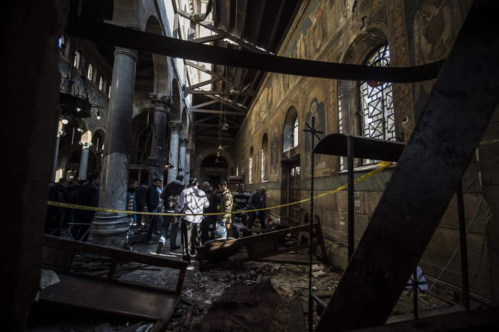 Egyptian security forces inspect the scene of a bomb explosion at the Saint Peter and Saint Paul Coptic Orthodox Church on December 11, 2016, in Cairo's Abbasiya neighbourhood. The blast killed at least 25 worshippers during Sunday mass inside the Cairo c