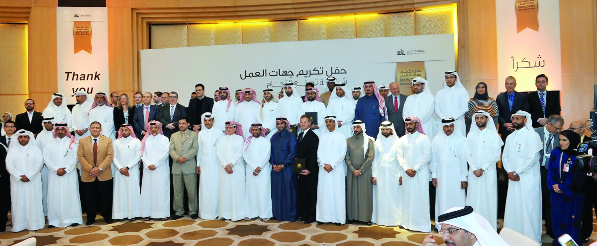 Dr Hassan Al Derham (first row, ninth left), President of Qatar University, with other officials and various company representatives during the Employer Recognition Ceremony held at Al Ghassar Ballroom yesterday. Pic: Kammutty VP/ The Peninsula