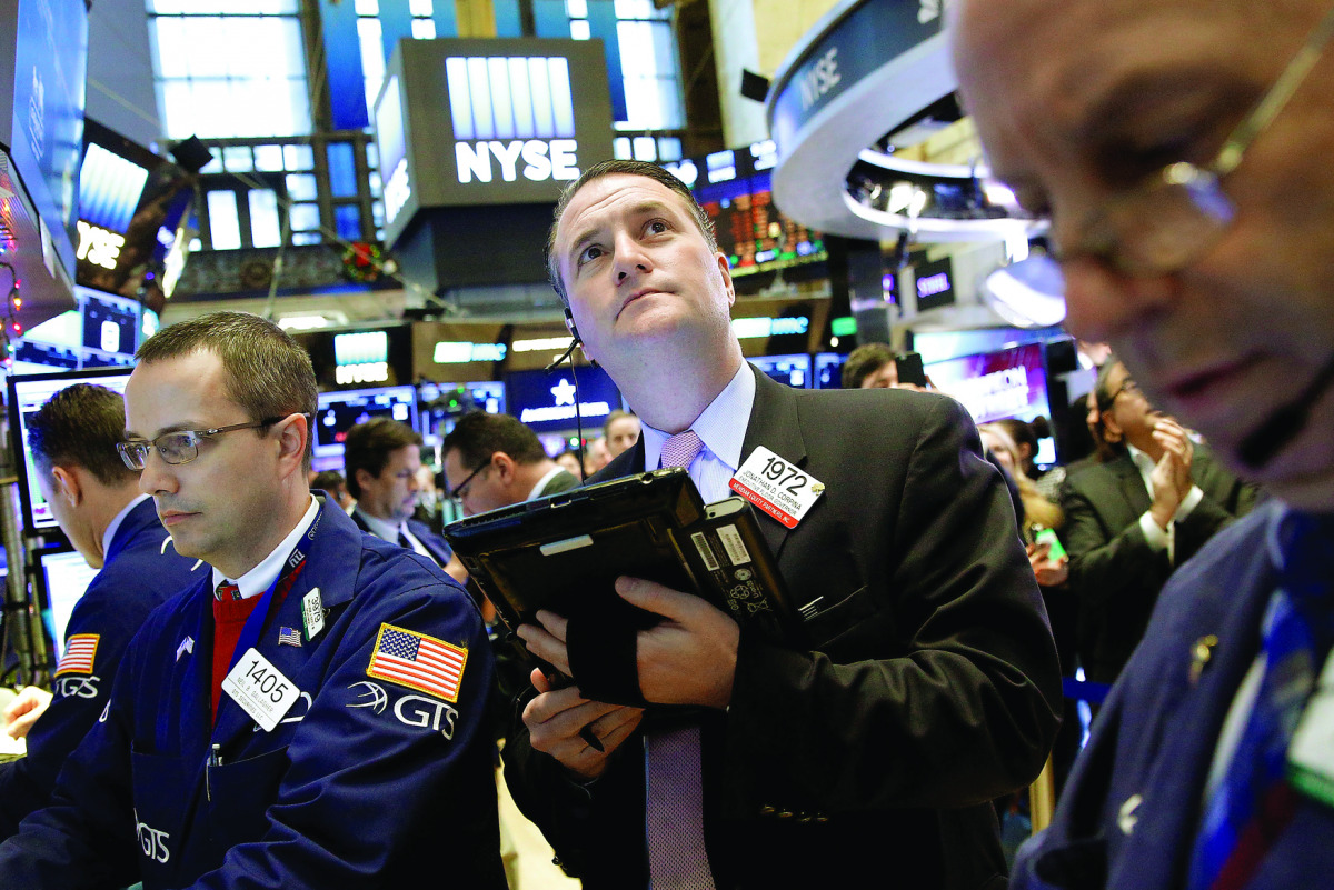 Traders work on the floor of the New York Stock Exchange (NYSE) yesterday.