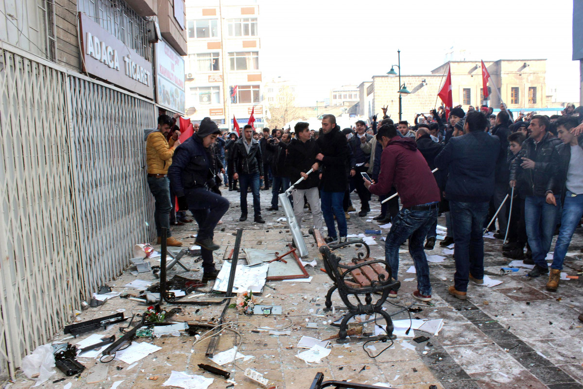 This picture obtained from Dogan News Agency shows people protesting in front of the offices of pro-Kurdish Peoples' Democratic Party (HDP) following a suicide car bombing on December 17, 2016 in Kayseri. Thirteen Turkish soldiers were killed and dozens m
