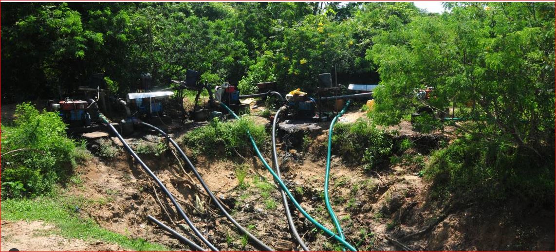 Engine-driven water pumps pull water from a storage tank intended for animals in southern Sri Lanka. TRF/Amantha Perera