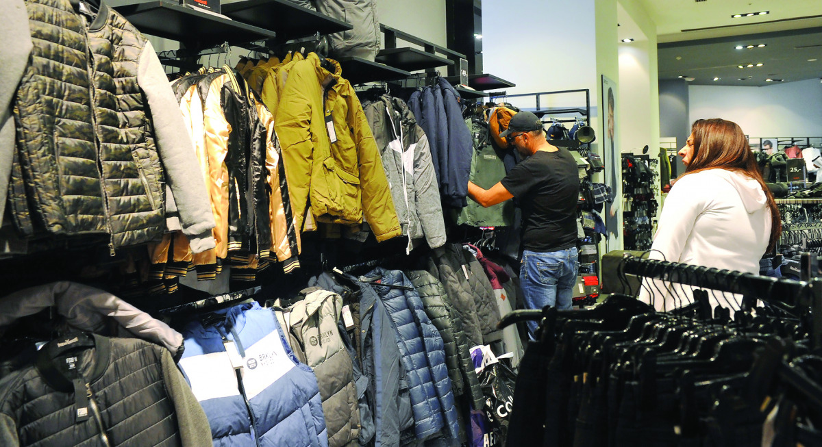Customers checking winter clothes at a shop in Ezdan Mall yesterday. The demand for winter wear has gone up with the mercury continuing to fall in Qatar. 
Pic: Kammutty V P / The Peninsula