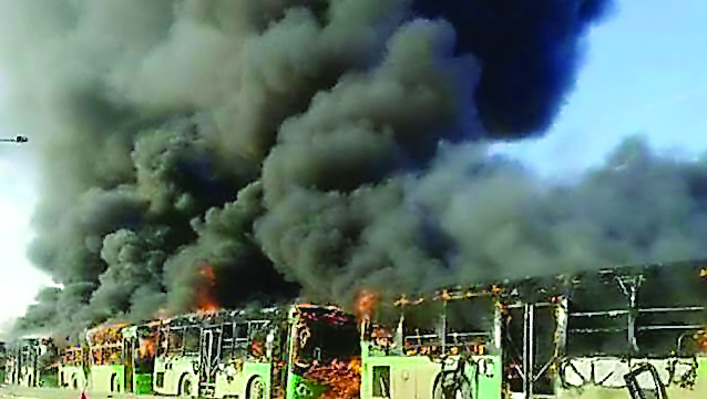Buses are seen after they were attacked and burned in Idlib province while en route to evacuate ill and injured people from the besieged Syrian villages of Al Foua and Kefraya, yesterday.