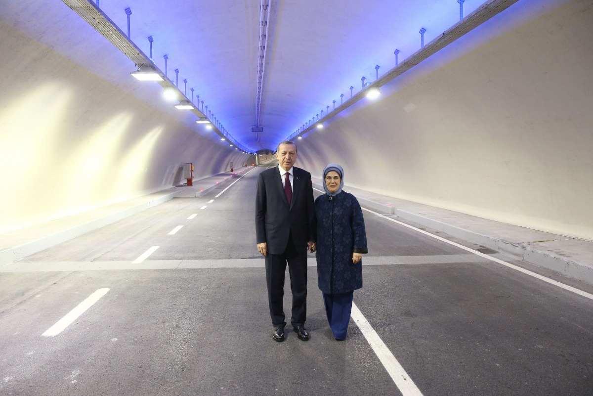 A handout picture released by the Turkish presidential press office shows Turkish President Recep Tayyip Erdogan (L) and his wife Emine Erdogan (R) posing in the tunnel on December 20, 2016 in Istanbul, during the opening cerenomy of the Avrasya (Eurasia)