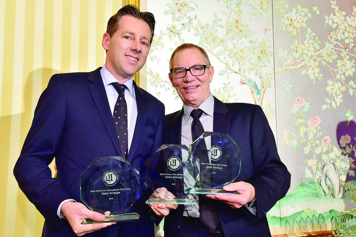 Qatar Airways Vice-President of the Americas, Gunter Saurwein (left) receiving the awards on behalf of the airline. Also seen is American comedian, Mack Dryden.