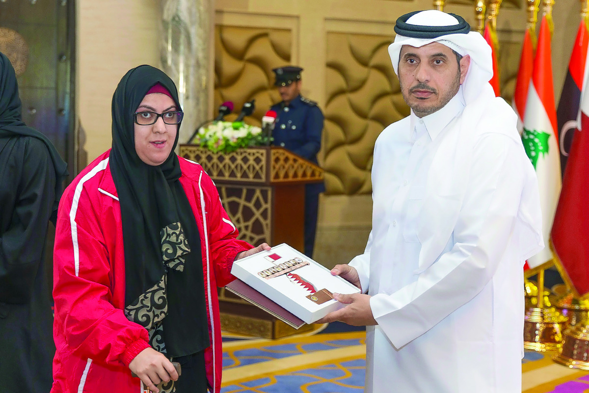 Prime Minister and Interior Minister H E Sheikh Abdullah bin Nasser bin Khalifa Al Thani honouring Sarah Masoud, who won the silver medal in the Women's Shotput F33 event in Paralympic Games in Rio de Janeiro, Brazil, during the 41st General Assembly of t