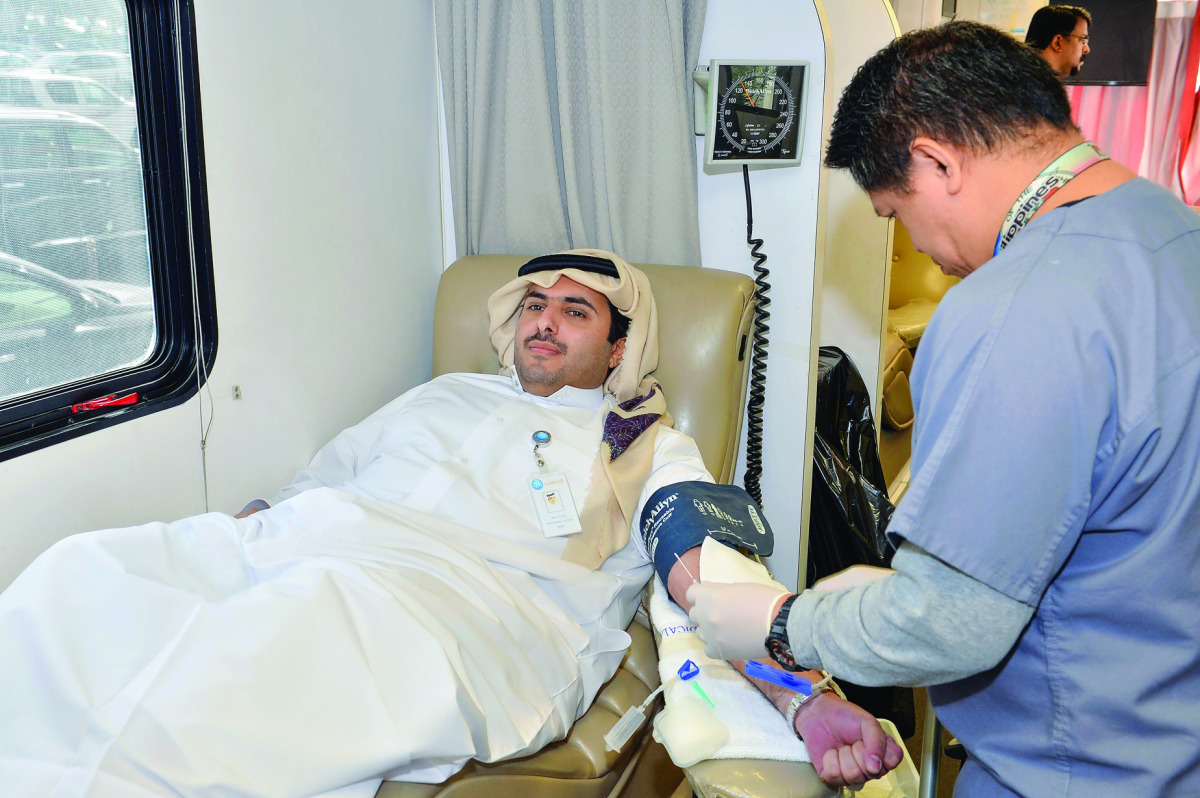 A Qatar Islamic Bank employee donating blood.