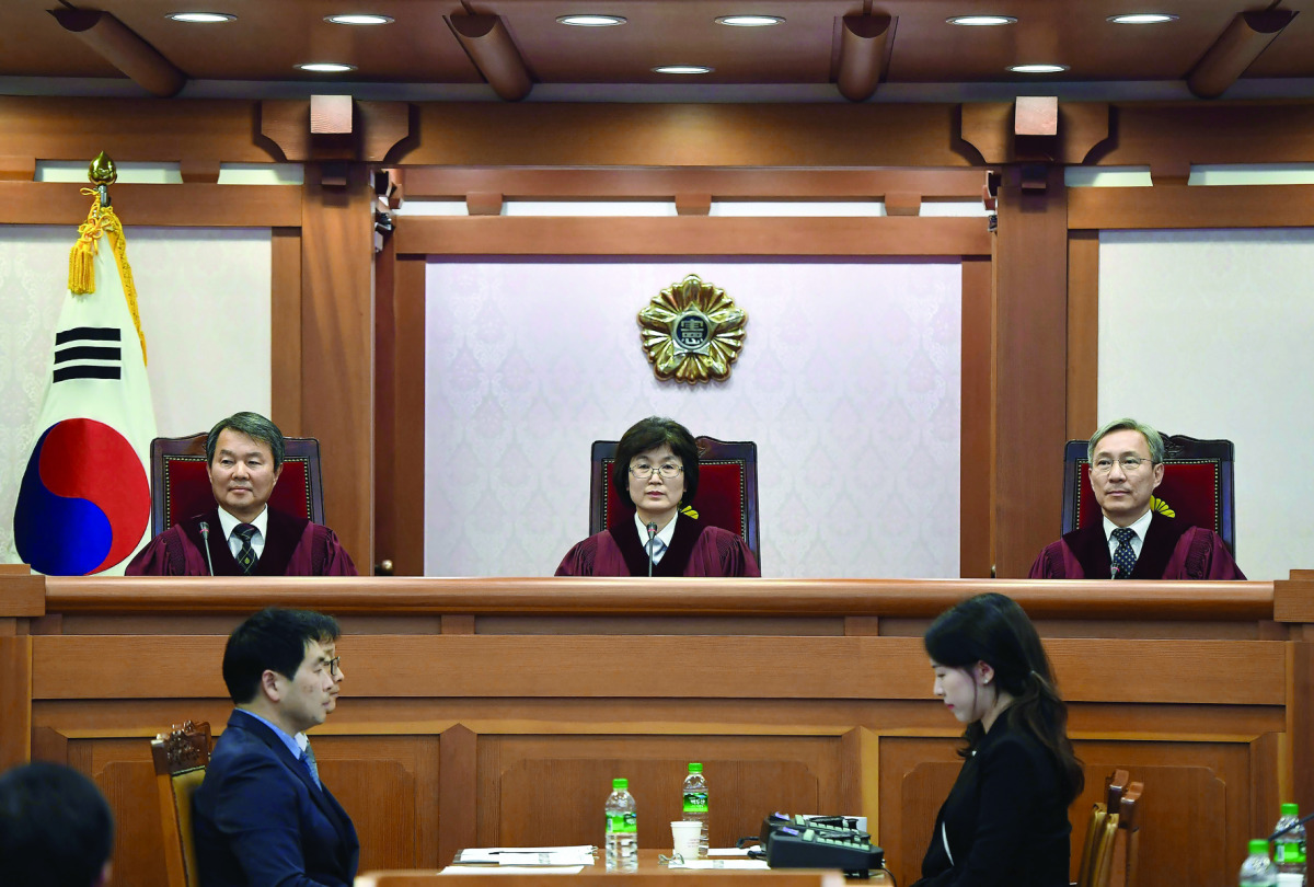South Korea's Constitutional Court judges (from left) Lee Jin-Sung, Lee Jung-Mi and Kang Il-Won attend a hearing into whether to confirm the impeachment of President Park Geun-Hye, at the Constitutional Court in Seoul, yesterday.