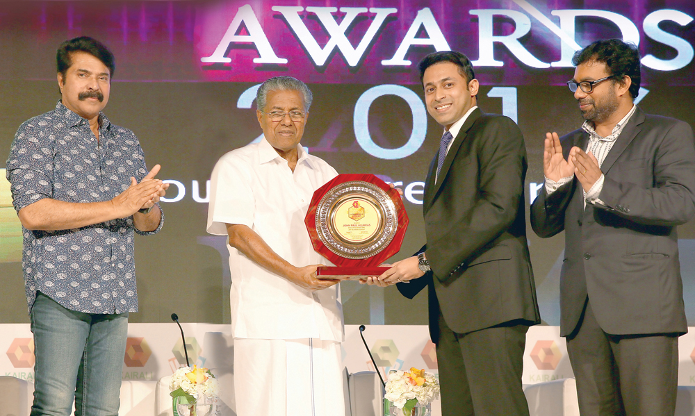 Joyalukkas Group Executive Director John Paul Alukkas (second right) receiving the Young NRI Entrepreneur of the Year Award for 2016 from Chief Minister of Kerala, Prinarayi Vijayan, as Malayalam Communications Ltd Chairman, and cinema superstar Mamooty (