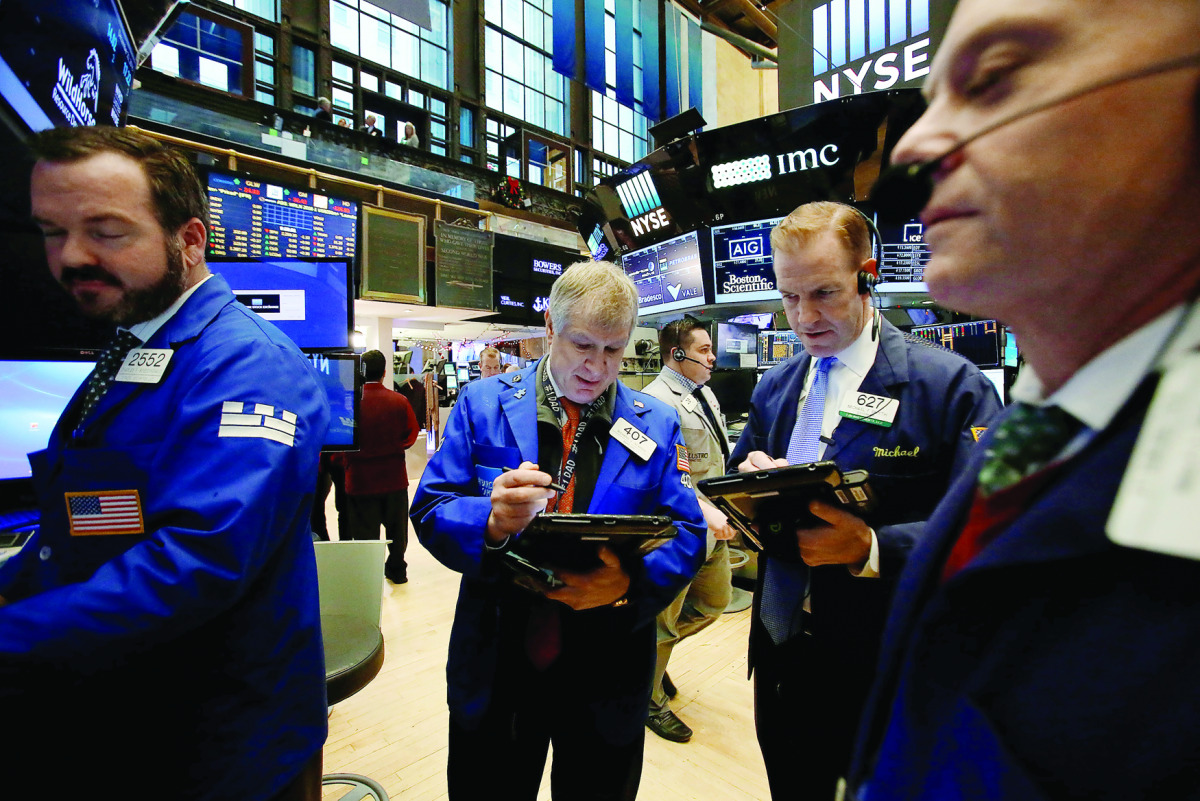 Traders work on the floor at the New York Stock Exchange in Manhattan, New York City.