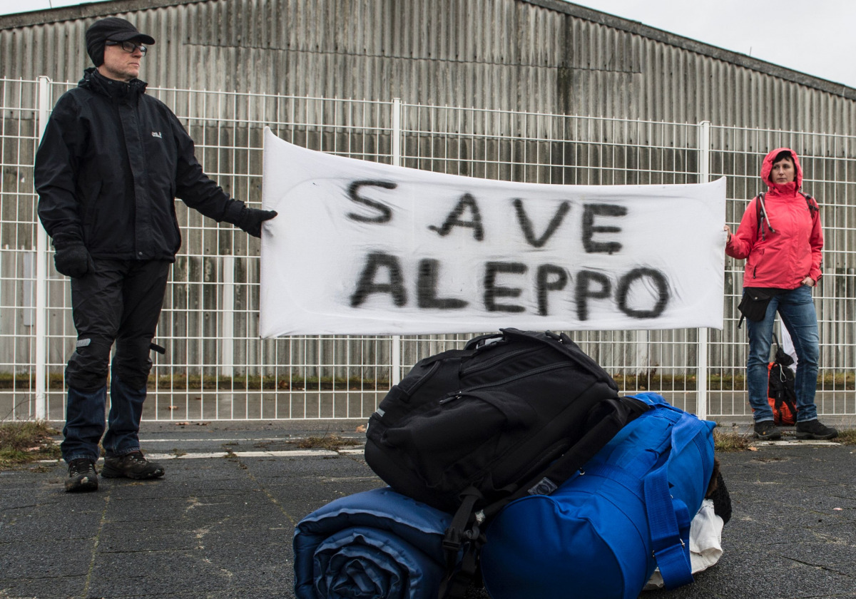 Participants of the solidarity march to Aleppo hold a banner reading 