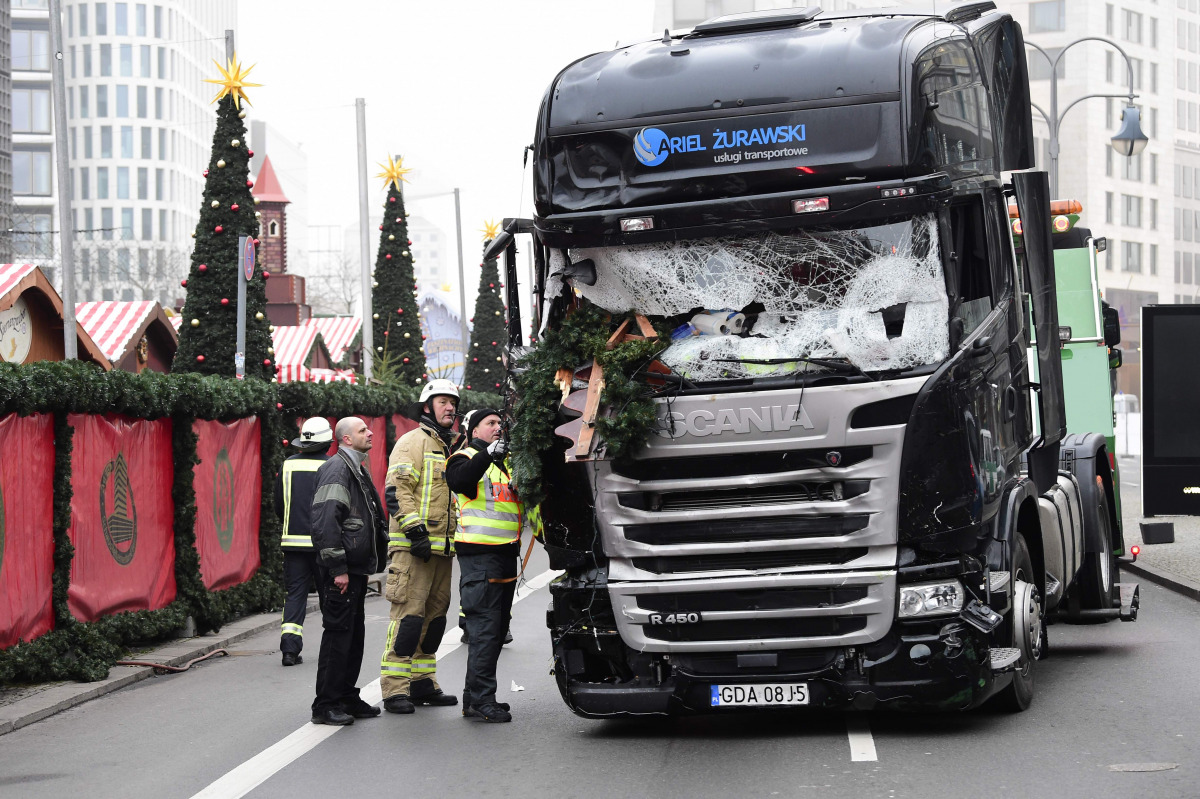 This file photo taken on December 20, 2016 shows firemen inspecting the truck that crashed the evening before into a Christmas market at Gedaechtniskirche church in Berlin. German police on December 28, 2016 detained a Tunisian national on suspicion of ha