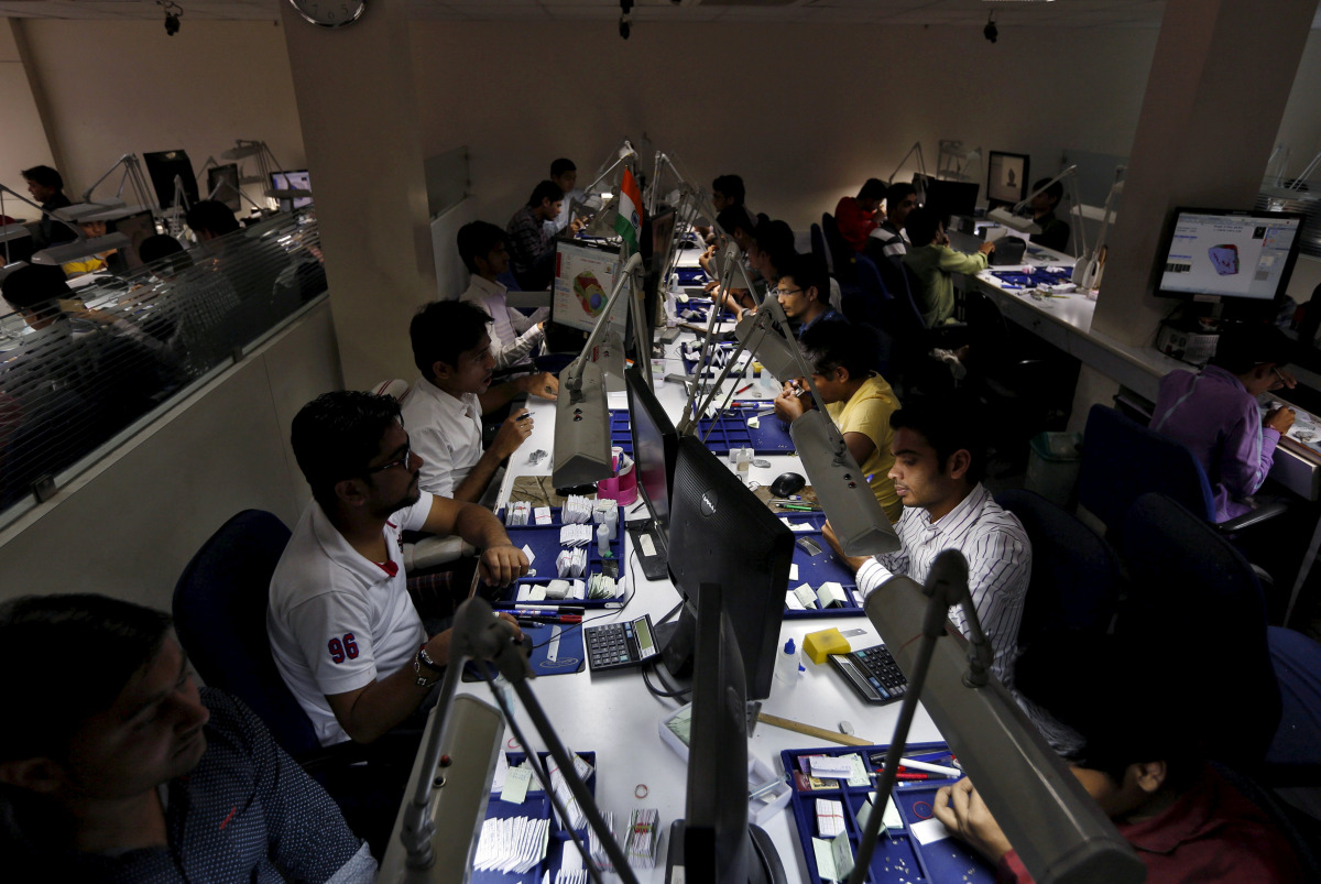 Craftsmen work at the polishing department of a diamond processing unit at Surat in Gujarat, India, August 31, 2015. (REUTERS/Amit Dave) 