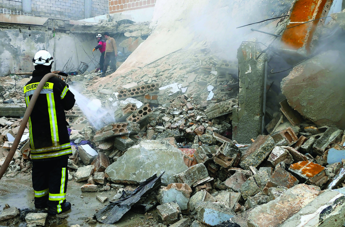 Fire fighters try to extinguish a fire after a car bomb  attack at the opposition controlled Soran district of Aleppo, Syria, yesterday.