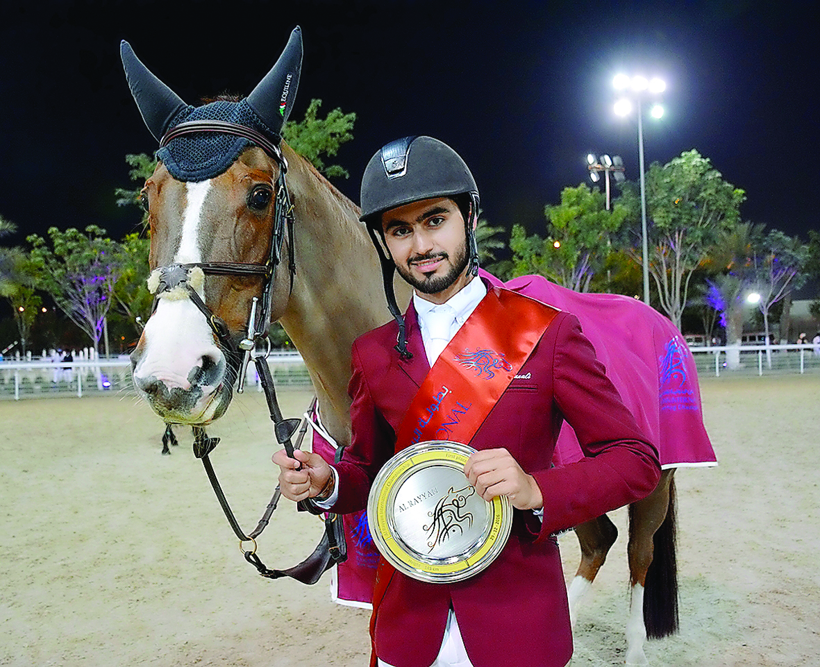 Qatari rider Nasser Al Ghazali, the winner of the  Special two phases, Art. 274.5.6 - 145 cm event, poses for a photograph with his trophy during the Al Rayyan International Show Jumping Championship in Doha yesterday. Pictures by Lotfi Garsi