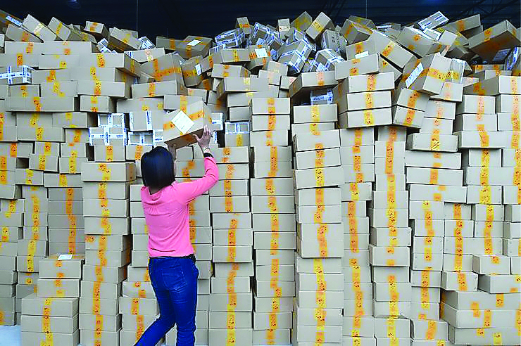 Singles' Day is a Chinese annual online shopping spree that has been held every November 11 since 2009. Picture shows an employee stacking the packets in an online store.