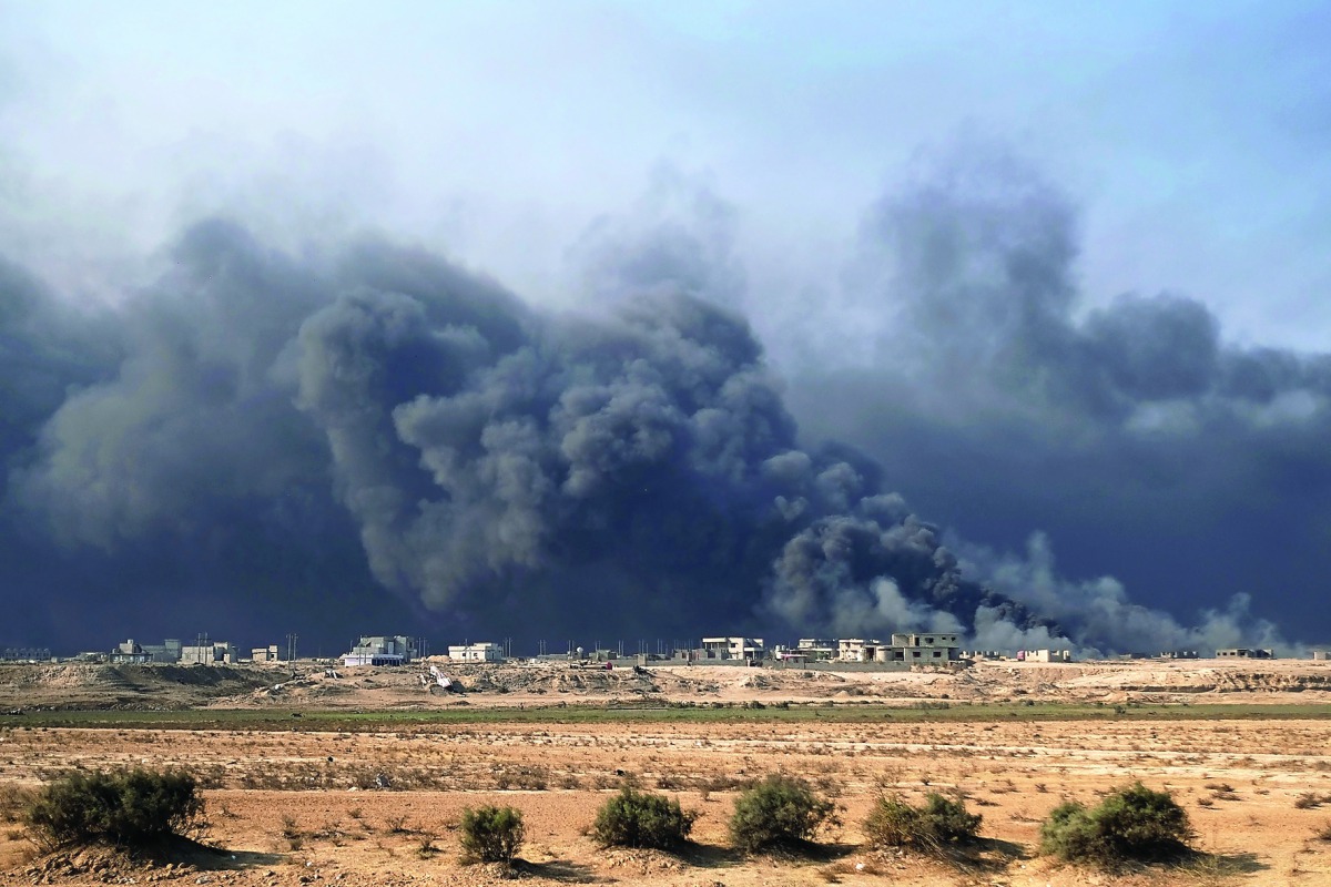 Smoke rises from burning oil wells in Qayyarah, south of Mosul.